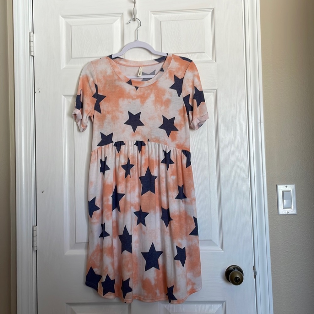 New without tags. Mini dress red and white with blue stars